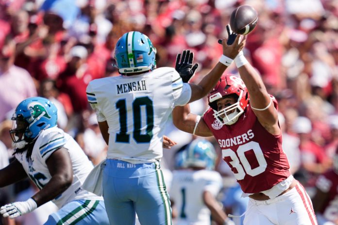 Oklahoma Sooners defensive lineman Trace Ford (30) pressures Tulane Green Wave quarterback Darian Mensah (10) during a college football game between the University of Oklahoma Sooners (OU) and the Tulane Green Wave at Gaylord Family - Oklahoma Memorial Stadium in Norman, Okla., Saturday, Sept. 14, 2024.