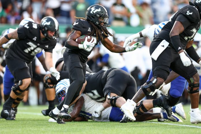 South Florida Bulls running back Ta'Ron Keith (9) runs with the ball against the Memphis Tigers in the fourth quarter at Camping World Stadium.