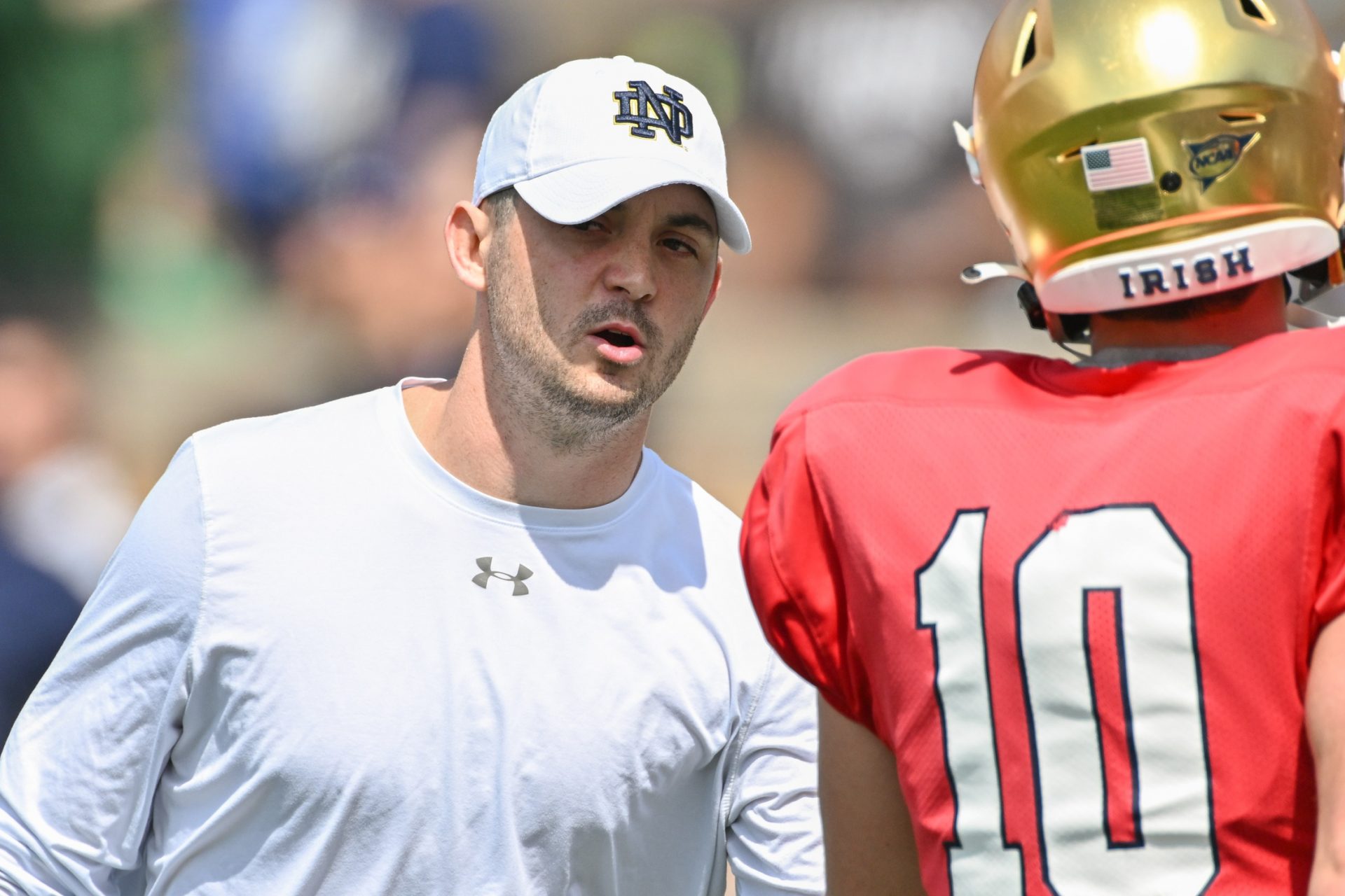 Notre Dame Fighting Irish offensive coordinator Tommy Rees talks to quarterback Drew Pyne (10) during warmups before the Blue-Gold Game at Notre Dame Stadium.