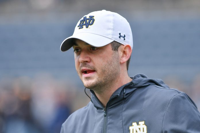 Notre Dame Fighting Irish quarterbacks coach Tom Rees talks to his players during warmups before the Blue-Gold Game at Notre Dame Stadium.