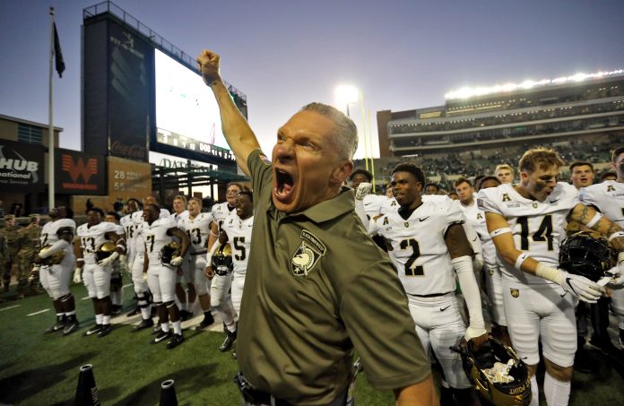 Army Black Knights head coach Jeff Monken celebrates with his players after 14-3 win against the North Texas Mean Green at DATCU Stadium.