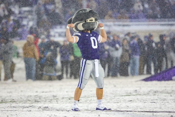 Kansas State Wildcats mascot Willie Wildcat flexes before the start of a game against the Iowa State Cyclones at Bill Snyder Family Football Stadium.