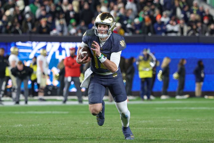 Notre Dame Fighting Irish quarterback Riley Leonard (13) rushes during the first half against the Army Black Knights at Yankee Stadium.