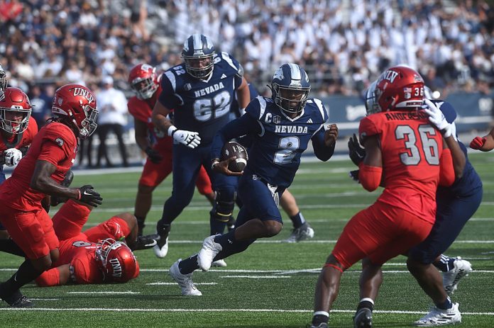 Nevada’s Brendon Lewis looks to run while taking on UNLV at Mackay Stadium in Reno on Oct. 14, 2023.