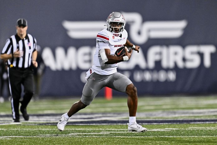 UNLV Rebels quarterback Hajj-Malik Williams (6) runs with the ball against the Utah State Aggies at Merlin Olsen Field at Maverik Stadium.