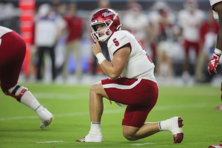 Miami Redhawks quarterback Brett Gabbert (5) gestures toward the Miami Hurricanes sideline during the first quarter at Hard Rock Stadium.