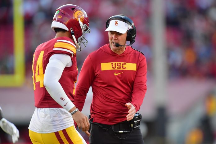 Southern California Trojans head coach Lincoln Riley greets quarterback Jayden Maiava (14) after scoring a touchdown against the Nebraska Cornhuskers during the second half at the Los Angeles Memorial Coliseum.