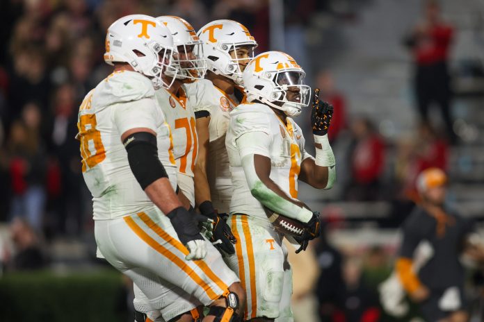 Tennessee Volunteers running back Dylan Sampson (6) celebrates with teammates after a touchdown against the Georgia Bulldogs in the second quarter at Sanford Stadium.