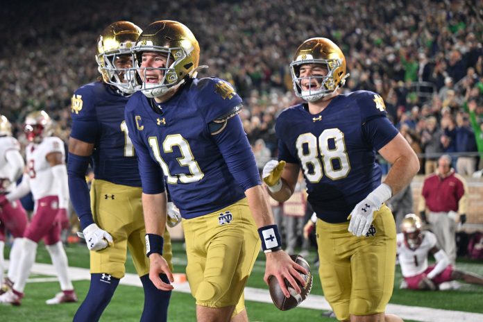 Notre Dame Fighting Irish quarterback Riley Leonard (13) celebrates after a touchdown against the Florida State Seminoles during the first quarter at Notre Dame Stadium.