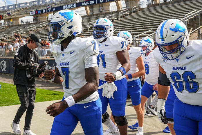 Buffalo Bulls quarterback C.J. Ogbonna (7) and teammates head to the field to warm up before the start of the game against the Connecticut Huskies at Rentschler Field at Pratt & Whitney Stadium.