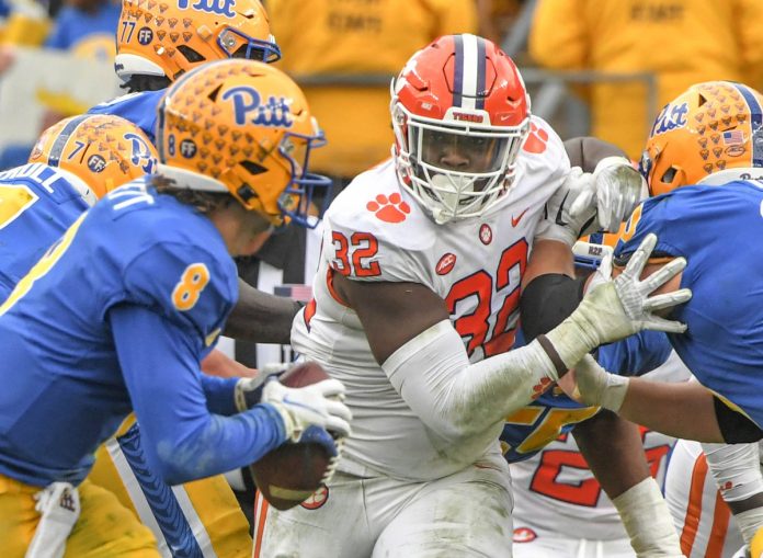 Clemson defensive tackle Etinosa Reuben (32) pressures Pitt quarterback Kenny Pickett (8) during the second quarter at Heinz Field in Pittsburgh, Pennsylvania, Saturday, October 23, 2021.