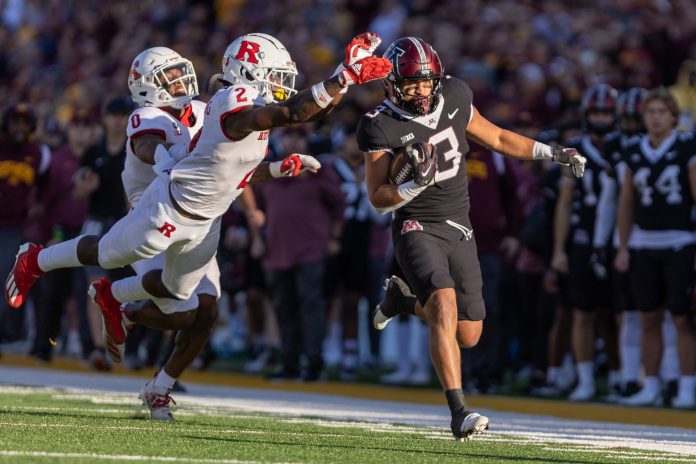 Rutgers Scarlet Knights defensive back Avery Young (2) tackles Minnesota Golden Gophers running back Trey Potts (3) after a long run in the fourth quarter at Huntington Bank Stadium.