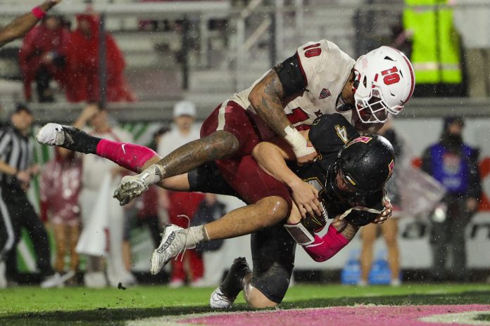 Appalachian State Mountaineers quarterback Joey Aguilar (4) scores a touchdown tackled by Miami (OH) Redhawks linebacker Ty Wise (10) in the third quarter during the Avocados from Mexico Cure Bowl at FBC Mortgage Stadium.