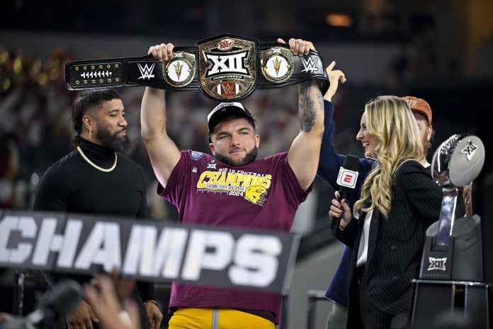 Arizona State Sun Devils running back Cam Skattebo (4) holds up the WWE Big 12 championship belt after the Sun Devils defeat the Iowa State Cyclones and win the 2024 Big 12 Championship at AT&T Stadium.