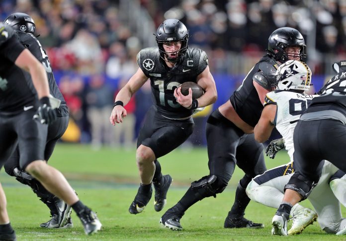 Army Black Knights quarterback Bryson Daily (13) runs with the ball against the Navy Midshipmen during the second half of the the 125th Army-Navy game at Northwest Stadium.