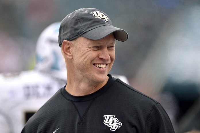 UCF Knights head coach Scott Frost smiles on the sidelines during the second half against the Temple Owls at Lincoln Financial Field.