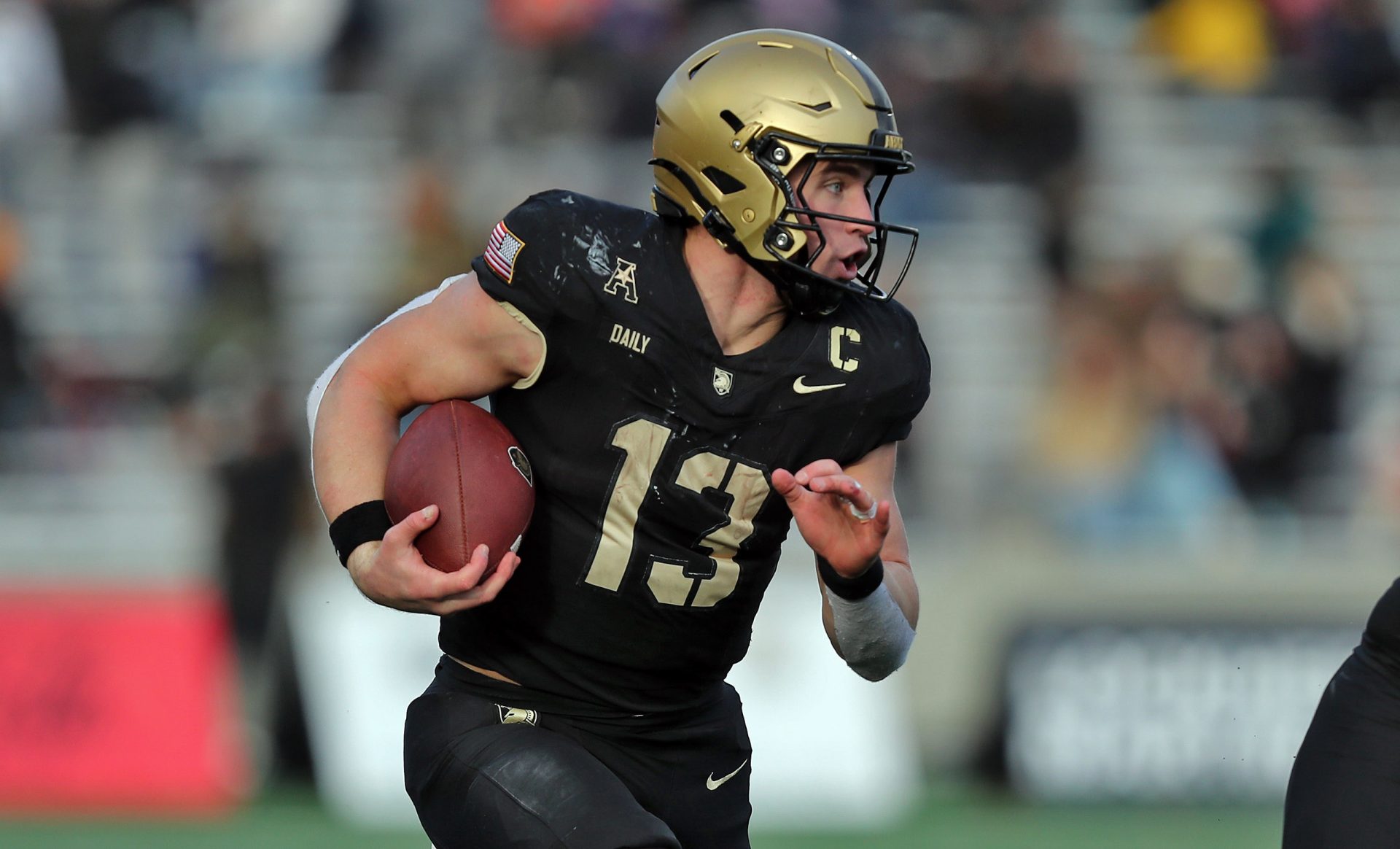 Army Black Knights quarterback Bryson Daily (13) carries the ball on an option run behind Army Black Knights offensive lineman Connor Finucane (60) during the second half against the UTSA Roadrunners at Michie Stadium.