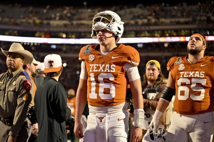 Texas Longhorns quarterback Arch Manning (16) walks off the field after UT defeats the Clemson Tigers in the CFP National Playoff first round game at Darrell K Royal-Texas Memorial Stadium.