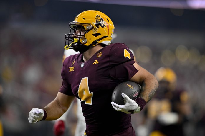 Arizona State Sun Devils running back Cam Skattebo (4) scores a rushing touchdown against the Iowa State Cyclones during the second half at AT&T Stadium.