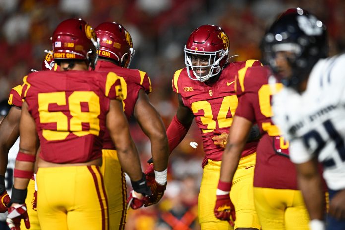 USC Trojans defensive end Braylan Shelby (34) celebrates after Utah State Aggies quarterback Bryson Barnes (16) (not pictured) is sacked during the third quarter at United Airlines Field at Los Angeles Memorial Coliseum.