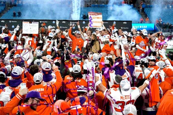 Dec 7, 2024; Charlotte, NC, USA; Clemson Tigers plaers celebrate after winning the 2024 ACC Championship game at Bank of America Stadium. Mandatory Credit: Bob Donnan-Imagn Images