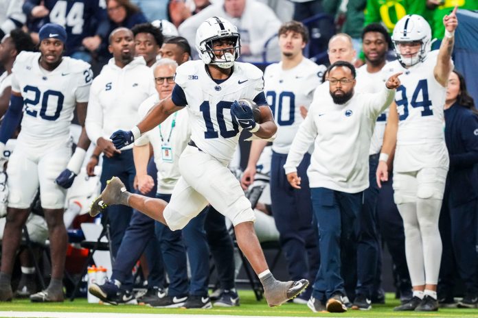 Penn State Nittany Lions running back Nicholas Singleton (10) carries the ball Saturday, Dec. 7, 2024, during the Big Ten Championship game between the Oregon Ducks and the Penn State Nittany Lions at Lucas Oil Stadium in Indianapolis.