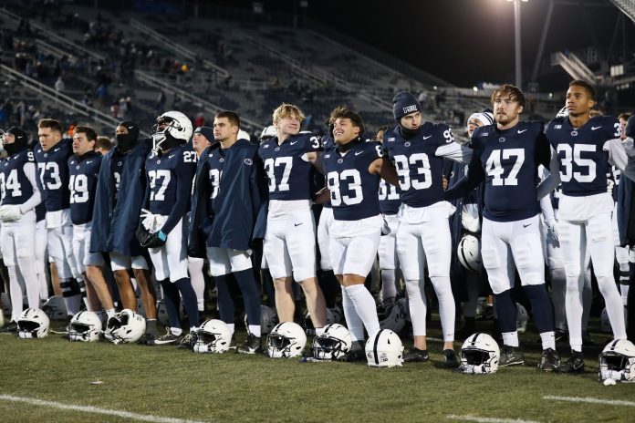 Nov 30, 2024; University Park, Pennsylvania, USA; Penn State Nittany Lion players sing their alma mater following a game against the Maryland Terrapins at Beaver Stadium. Penn State won 44-7. Mandatory Credit: Matthew O'Haren-Imagn Images