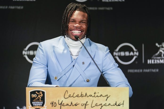 Colorado Buffaloes wide receiver/cornerback Travis Hunter speaks to the press after winning the 2024 Heisman Trophy.