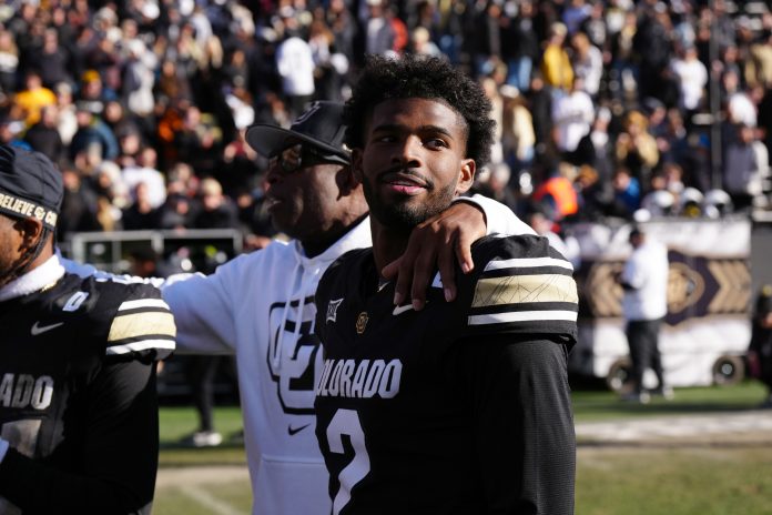 Colorado Buffaloes quarterback Shedeur Sanders (2) and head coach Deion Sanders ifollowing the win over the Oklahoma State Cowboys at Folsom Field.