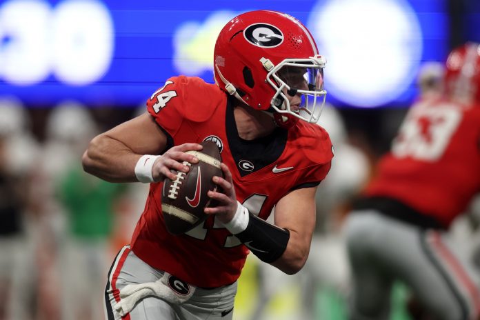 Georgia Bulldogs quarterback Gunner Stockton (14) drops back to pass against the Texas Longhorns during the second half in the 2024 SEC Championship game at Mercedes-Benz Stadium.