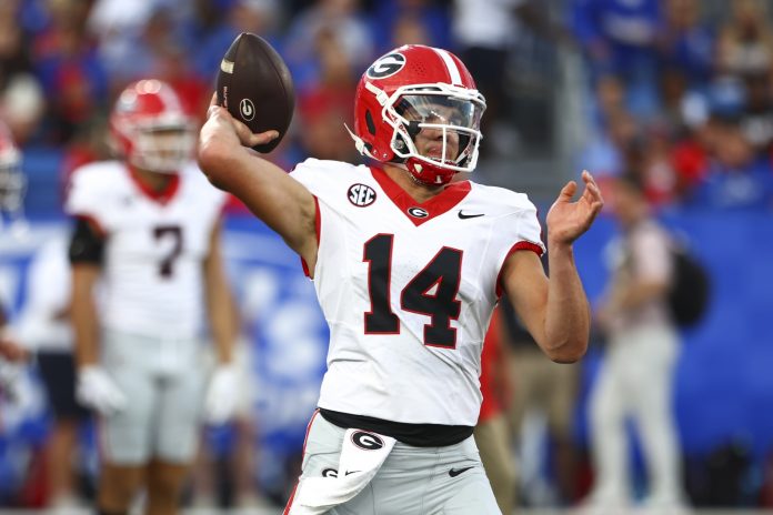 Georgia Bulldogs quarterback Gunner Stockton (14) warms up before the game against Kentucky Wildcats at Kroger Field.