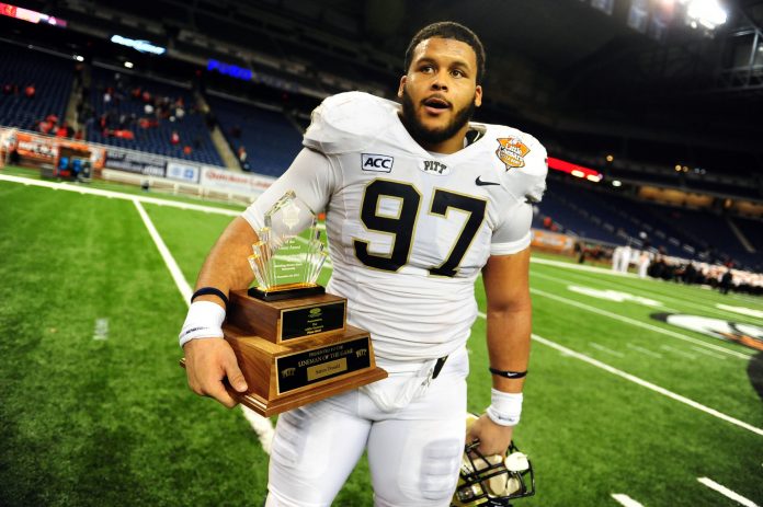 Pittsburgh Panthers defensive lineman Aaron Donald (97) holds the lineman of the game trophy after defeating Bowling Green Falcons 30-27 to win the Little Caesars Pizza Bowl at Ford Field.