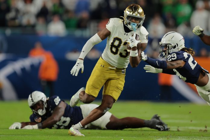 Notre Dame Fighting Irish wide receiver Jayden Thomas (83) runs pressured by Penn State Nittany Lions defensive tackle Zane Durant (28) in the second half in the Orange Bowl at Hard Rock Stadium.