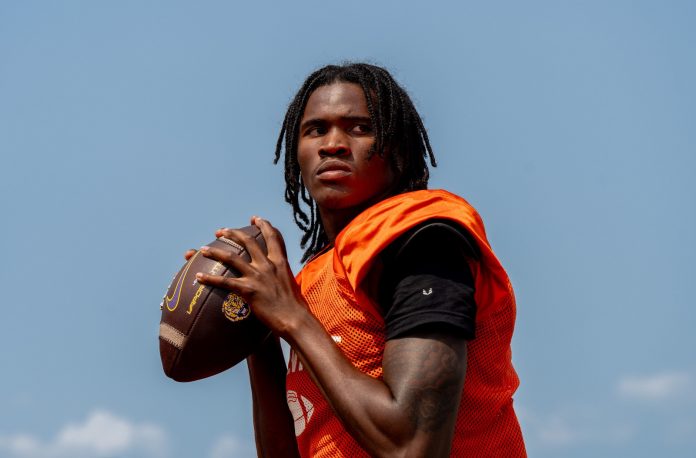 Quarterback Bryce Underwood prepares to throw a pass during a team practice at the Belleville High School football field in Belleville on Wednesday, Aug. 14, 2024.