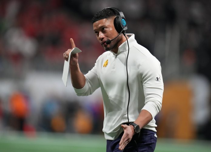 Notre Dame Fighting Irish head coach Marcus Freeman reacts against the Ohio State Buckeyes in the second half in the CFP National Championship college football game at Mercedes-Benz Stadium.