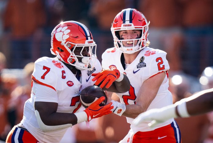 Clemson Tigers quarterback Cade Klubnik (2) hands the ball off to running back Phil Mafah (7) in the first quarter as the Texas Longhorns play the Clemson Tigers in the first round of the College Football Playoffs at Darrell K Royal Texas Memorial Stadium in Austin, Texas, Dec. 21, 2024.