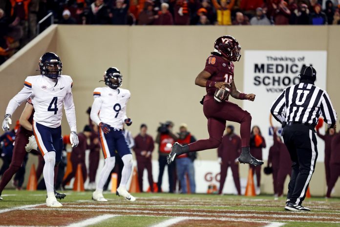 Virginia Tech Hokies quarterback William Watson III (18) scores a touchdown during the third quarter against the Virginia Cavaliers at Lane Stadium.