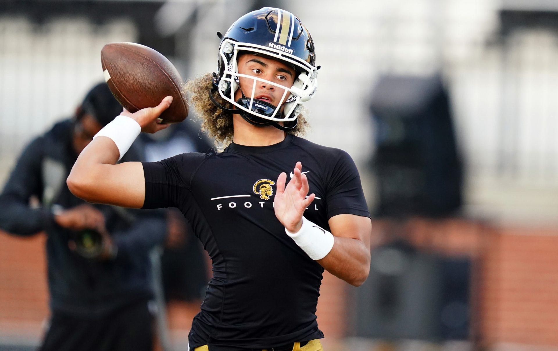 Carrollton Trojans quarterback Julian Lewis (10) runs through drills during warmups before their game against the Westlake Lions at Grisham Stadium. The 15-year-old Carrollton High student has already committed to playing for the University of Southern California Trojans and has been considered one of the top high school quarterback prospects.