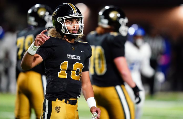 Carrollton Trojans quarterback Julian Lewis (10) looks for the play call against the Westlake Lions during the first half at Grisham Stadium. The 15-year-old Carrollton High student has already committed to playing for the University of Southern California Trojans and has been considered one of the top high school quarterback prospects.