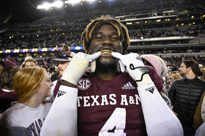 Texas A&M Aggies defensive lineman Shemar Stewart (4) shows off his gold grill smile after the Aggies defeat the LSU Tigers at Kyle Field.