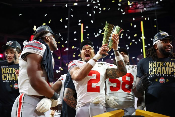 Ohio State Buckeyes wide receiver Emeka Egbuka (2) celebrates after winning against the Notre Dame Fighting Irish in the CFP National Championship college football game at Mercedes-Benz Stadium.