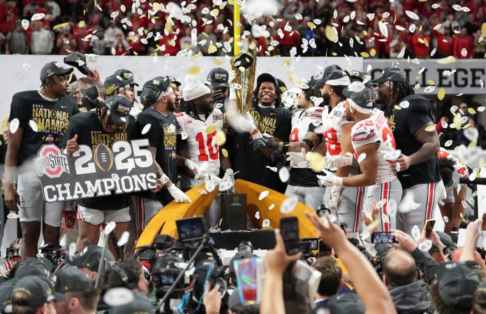 Ohio State Buckeyes players celebrate with the CFP National Championship trophy after defeating the Notre Dame Fighting Irish in the CFP National Championship college football game at Mercedes-Benz Stadium.