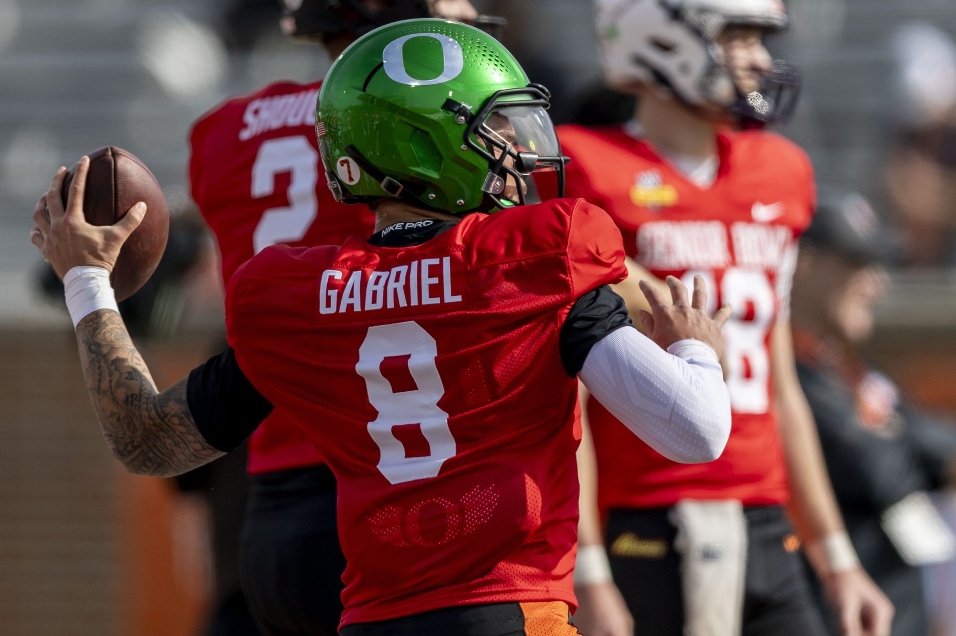 National team quarterback Dillon Gabriel of Oregon (8) throws the ball during Senior Bowl practice for the National team at Hancock Whitney Stadium.