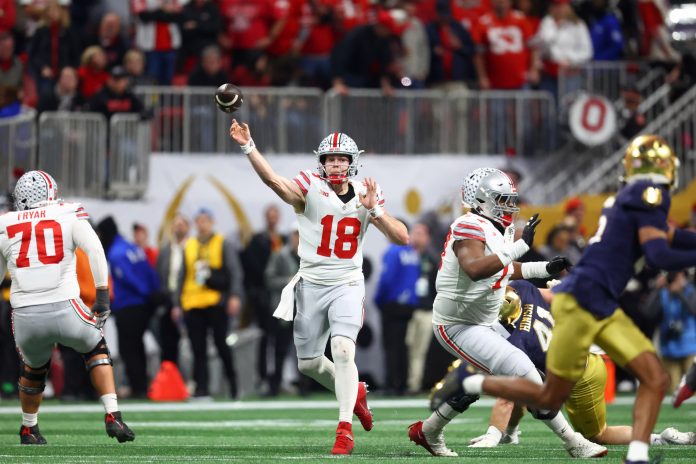 Ohio State Buckeyes quarterback Will Howard (18) passes the ball against the Notre Dame Fighting Irish during the first half the CFP National Championship college football game at Mercedes-Benz Stadium.