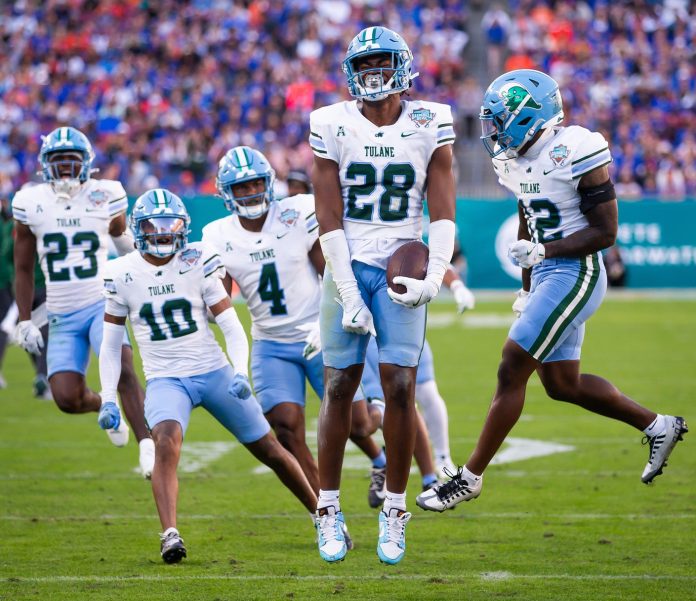 Tulane Green Wave linebacker Dickson Agu (28) celebrates after intercepting the ball during the first half at Raymond James Stadium in Tampa, FL on Friday, December 20, 2024 in the 2024 Union Home Mortgage Gasparilla Bowl. [Doug Engle/Gainesville Sun]