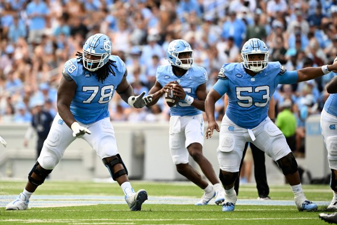 North Carolina Tar Heels quarterback Conner Harrell (15) looks to pass as offensive linemen Trevyon Green (78) and Willie Lampkin (53) block in the second quarter at Kenan Memorial Stadium.