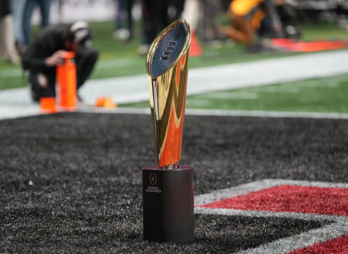 CFP National Championship trophy on the field before the CFP National Championship college football game between the Notre Dame Fighting Irish and the Ohio State Buckeyes at Mercedes-Benz Stadium.