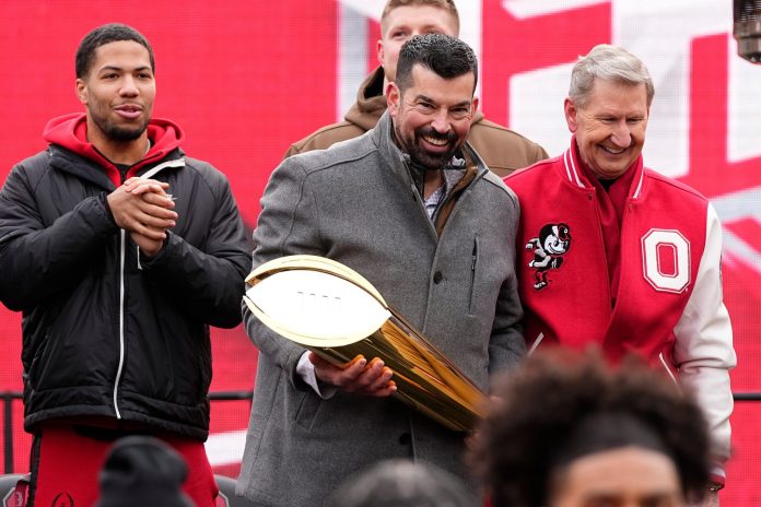 Ohio State Buckeyes head coach Ryan Day holds the College Football Playoff trophy during the Ohio State Buckeyes National Championship celebration at Ohio Stadium in Columbus on Jan. 26, 2025.