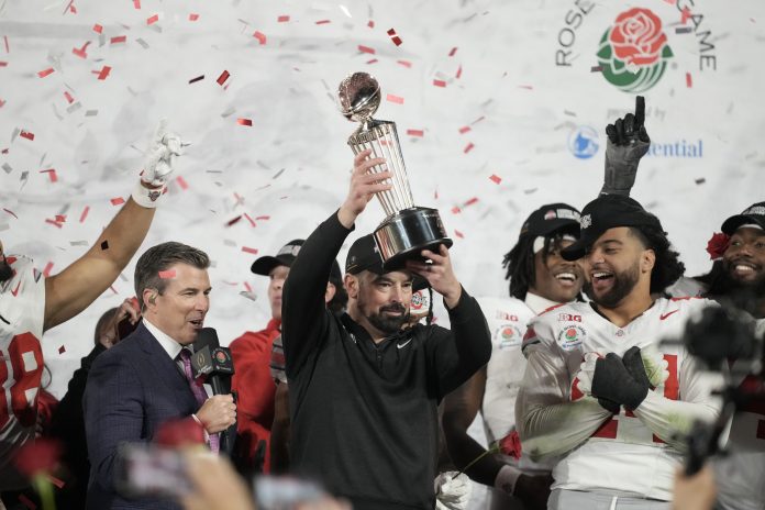 Ohio State Buckeyes head coach Ryan Day celebrates with the Leishman Trophy after defeating the Oregon Ducks in the 2025 Rose Bowl college football quarterfinal game at Rose Bowl Stadium.