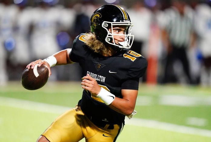 Carrollton Trojans quarterback Julian Lewis (10) scrambles out of the pocket against the Westlake Lions during the first half at Grisham Stadium. The 15-year-old Carrollton High student has already committed to playing for the University of Southern California Trojans and has been considered one of the top high school quarterback prospects.